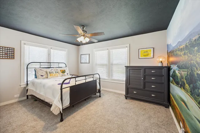 a bedroom with a bed and a chandelier