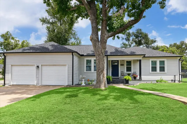 a front view of a house with a garden and porch
