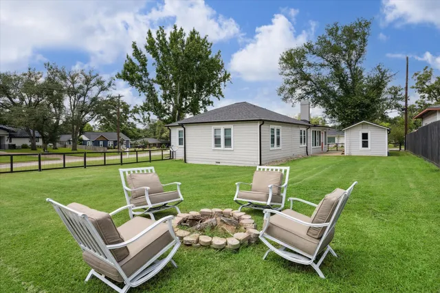 a view of a house with a yard and patio