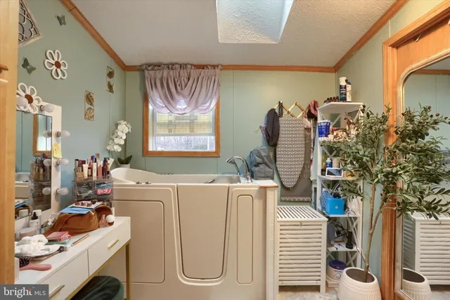 a living room with furniture a window and a flat screen tv