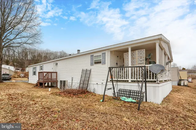 a backyard of a house with yard and outdoor seating
