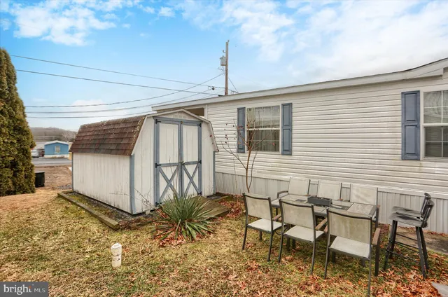 a view of a chairs and table in backyard