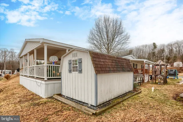 a backyard of a house with barbeque oven table and chairs