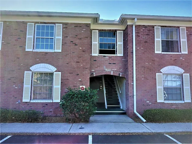 a front view of a house with plants