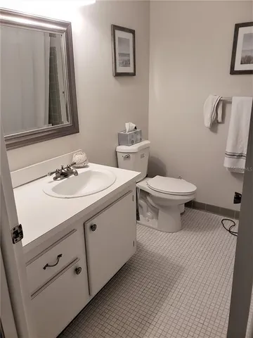 a bathroom with a sink toilet and mirror