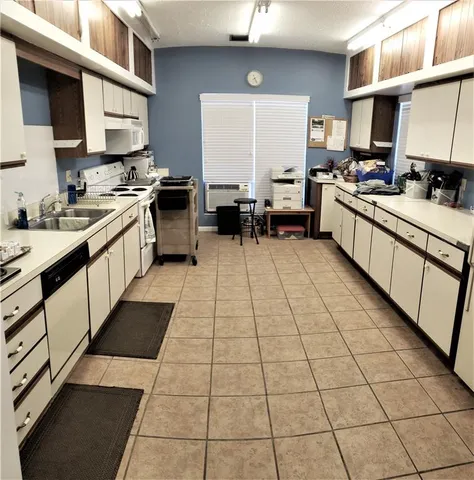 a kitchen with stainless steel appliances a sink stove and cabinets