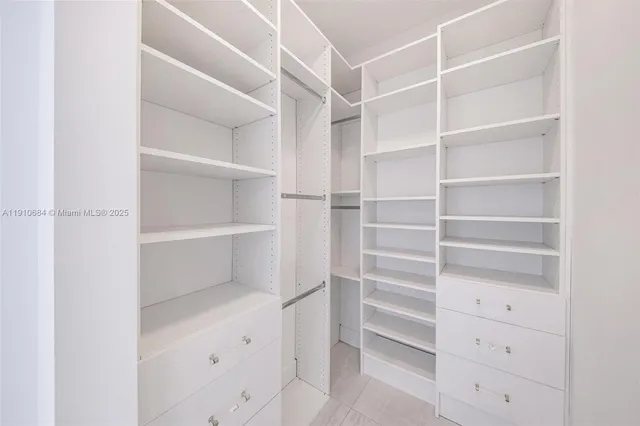 a view of kitchen with refrigerator and a window