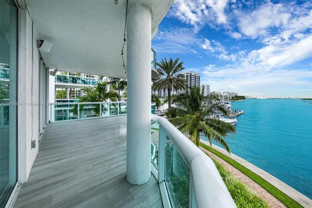 a view of a balcony with table and chairs and wooden floor