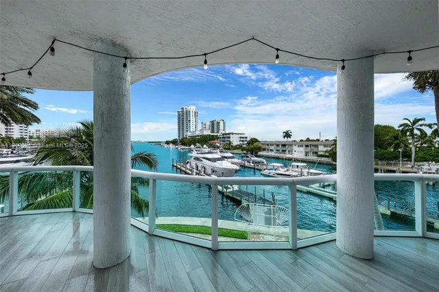 a large kitchen with stainless steel appliances granite countertop a large counter top a stove and a refrigerator with cabinets