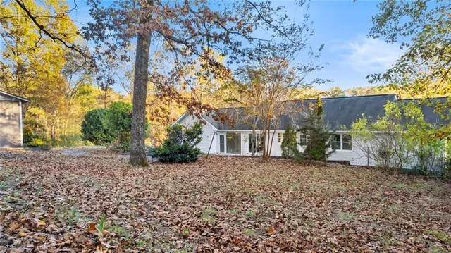 a view of a backyard with large trees