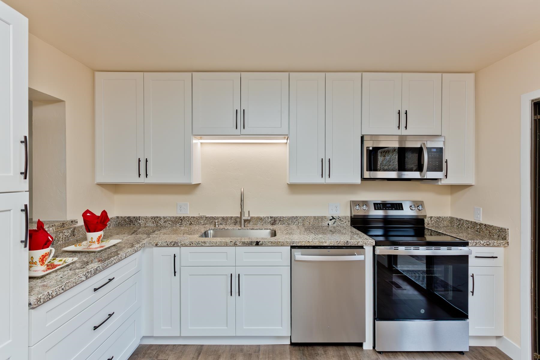 575-28 28 1/2 Road, Unit 44 Grand Junction, CO 81501 - Photo 10 of 39 a kitchen with granite countertop white cabinets and white appliances