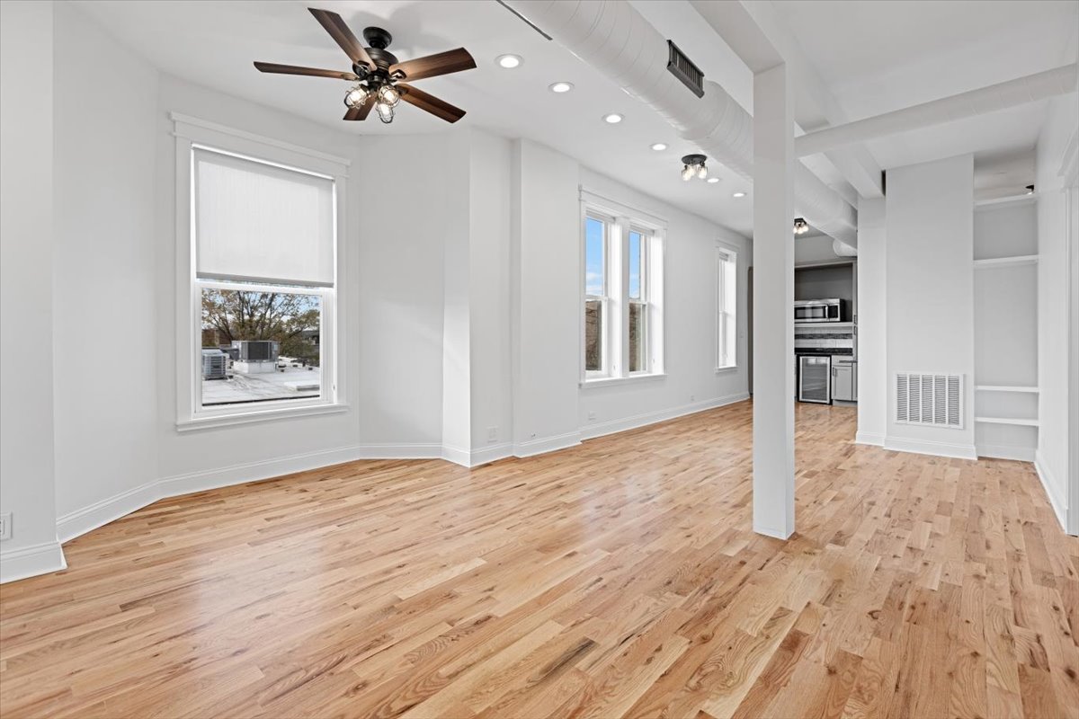 2346 West Fullerton Avenue, Unit 3 Chicago, IL 60647 - Photo 11 of 15 wooden floor in an empty room with a window