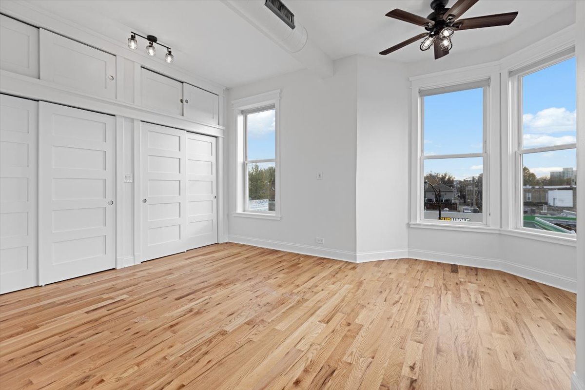 2346 West Fullerton Avenue, Unit 3 Chicago, IL 60647 - Photo 12 of 15 a view of empty room with wooden floor and fan