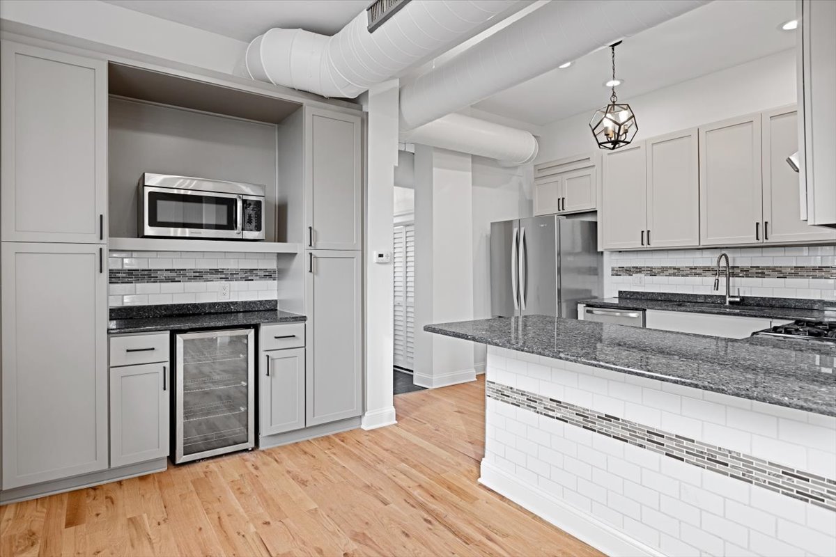 2346 West Fullerton Avenue, Unit 3 Chicago, IL 60647 - Photo 3 of 15 a kitchen with stainless steel appliances granite countertop a stove and cabinets
