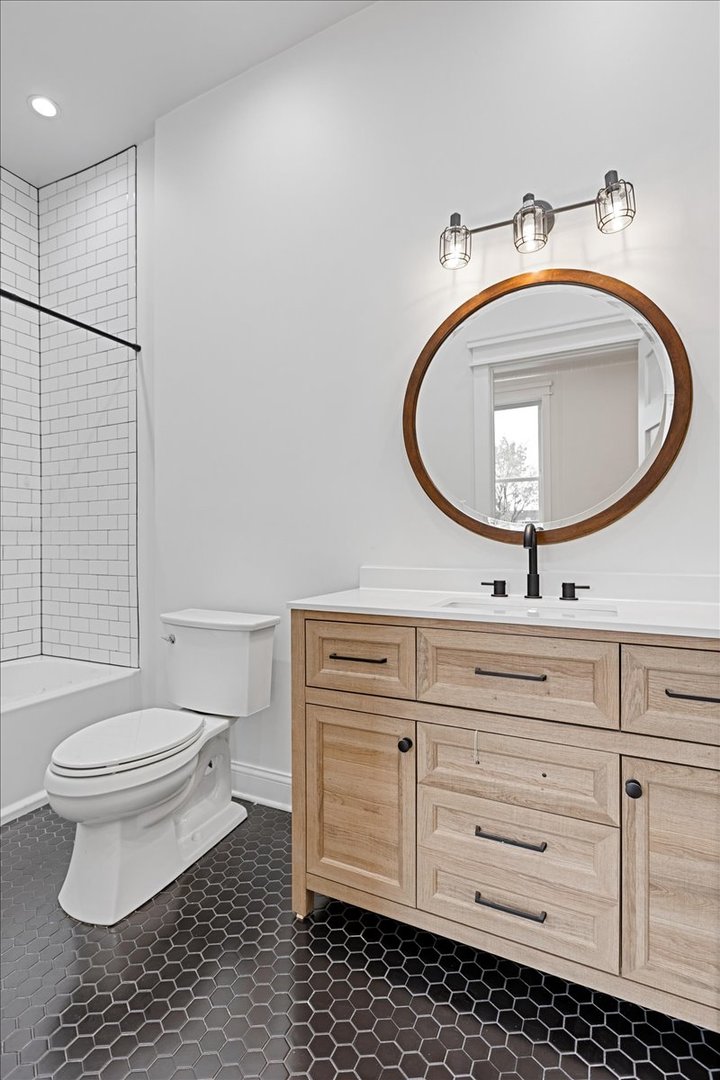2346 West Fullerton Avenue, Unit 3 Chicago, IL 60647 - Photo 7 of 15 a bathroom with a toilet a sink and mirror