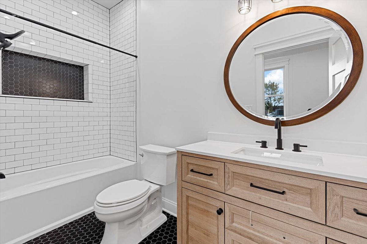 2346 West Fullerton Avenue, Unit 3 Chicago, IL 60647 - Photo 8 of 15 a bathroom with a sink a toilet and a mirror
