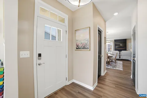 a view of a livingroom with wooden floor and a flat screen tv