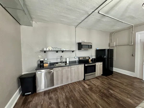 a living room with furniture a ceiling fan and a flat screen tv