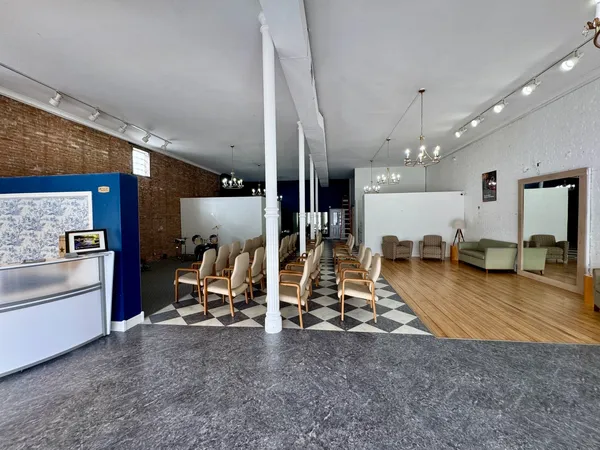 a view of a room with wooden floor
