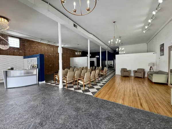 a living room with lots of furniture and a chandelier