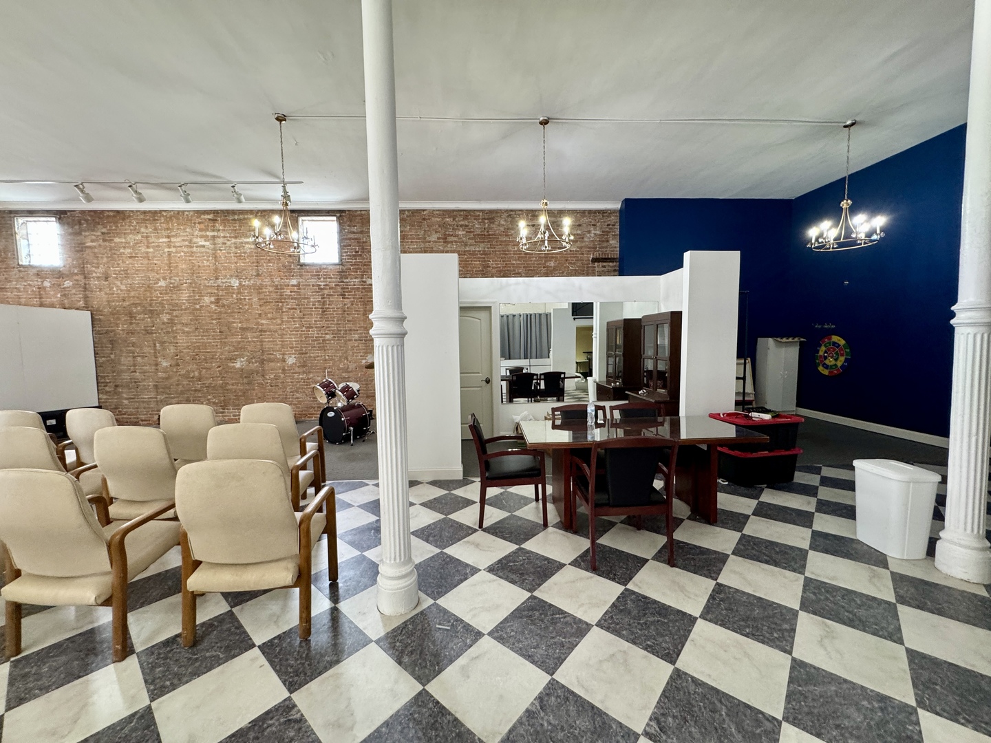 902 North Main Street Princeton, IL 61356 - Photo 9 of 33 a room with a black white checkered floor with couches chair and a coffee table