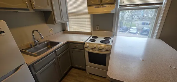 a kitchen with a stove and a window