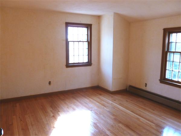 20 West Colonial Road Wilbraham, MA 01095 - Photo 13 of 18 an empty room with wooden floor and windows