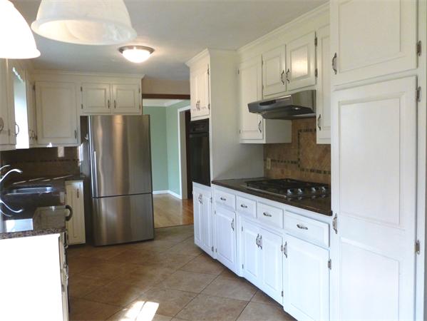 20 West Colonial Road Wilbraham, MA 01095 - Photo 6 of 18 a kitchen with granite countertop a refrigerator and a stove