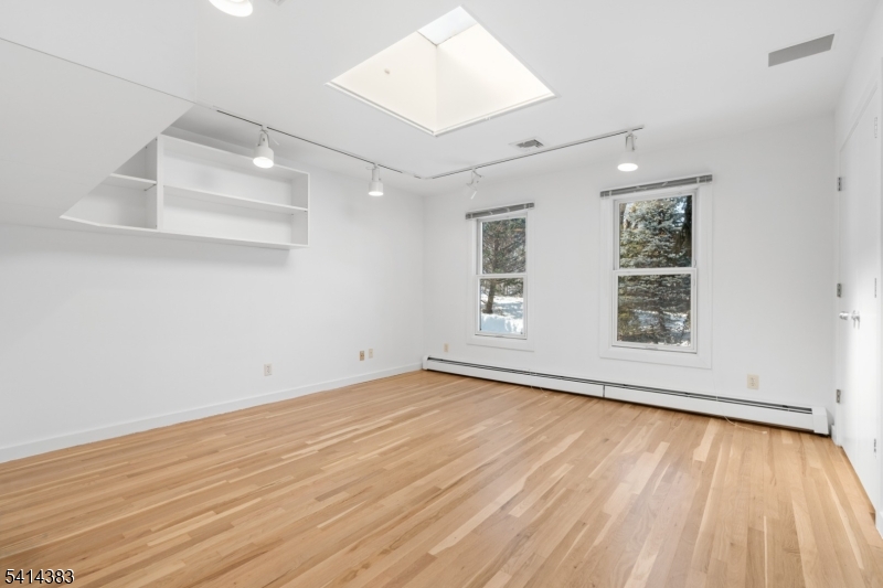 2 Old Mill Road North Caldwell, NJ 07006 - Photo 16 of 25 an empty room with wooden floor and windows