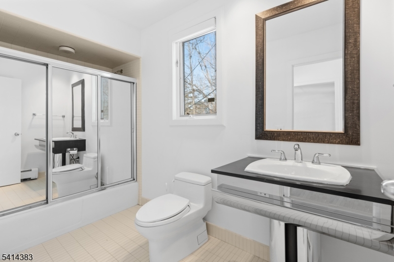 2 Old Mill Road North Caldwell, NJ 07006 - Photo 18 of 25 a bathroom with a granite countertop sink mirror vanity and toilet