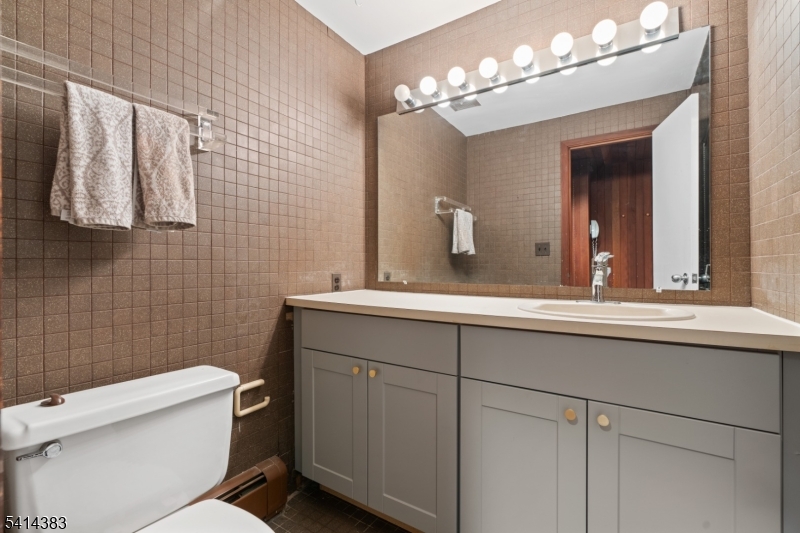 2 Old Mill Road North Caldwell, NJ 07006 - Photo 22 of 25 a bathroom with a sink a toilet and mirror