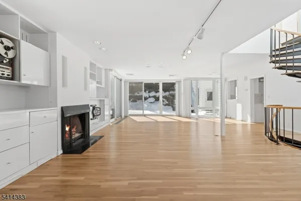 a view of a living room with furniture and a fireplace