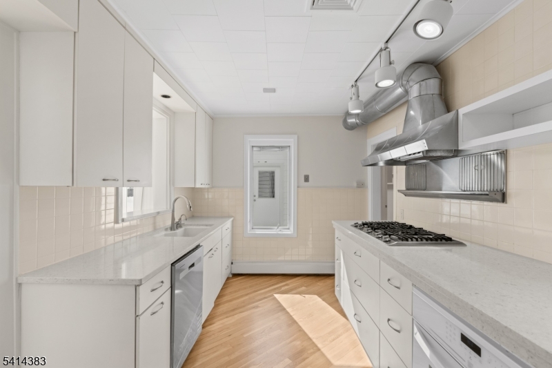 2 Old Mill Road North Caldwell, NJ 07006 - Photo 7 of 25 a kitchen with granite countertop a sink stove and cabinets