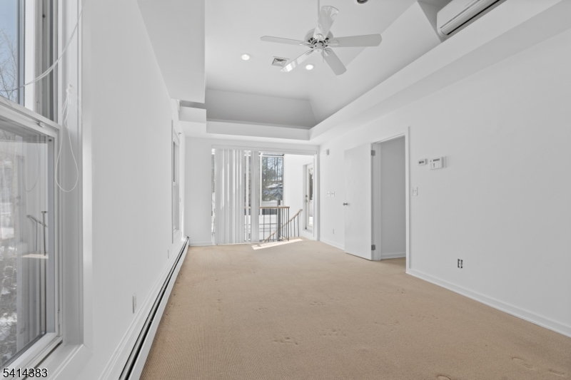 2 Old Mill Road North Caldwell, NJ 07006 - Photo 10 of 25 a view of a livingroom with a ceiling fan & entryway