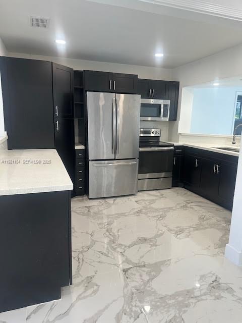 2220 Southwest 67th Way Miramar, FL 33023 - Photo 2 of 13 a kitchen with kitchen island a counter top space appliances and cabinets