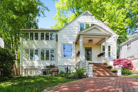 a kitchen with stainless steel appliances kitchen island granite countertop a stove and white cabinets