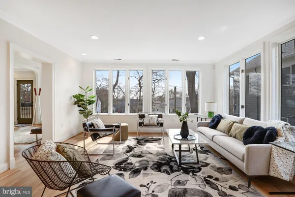 a living room with furniture fireplace and a large window
