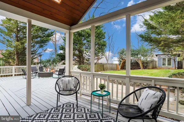 a view of a chairs and table in patio with a fire pit