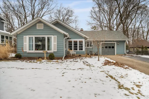 a front view of a house with a yard and more windows