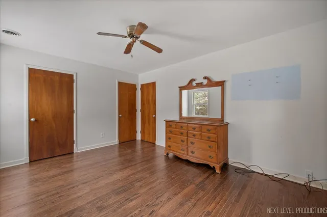 a view of room with hardwood floor and cabinet