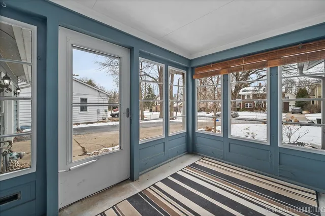 a view of a room with wooden floor and windows