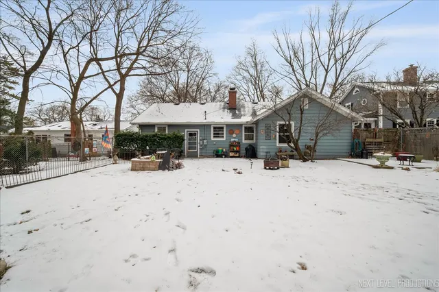 a view of a white house with a snow in the yard