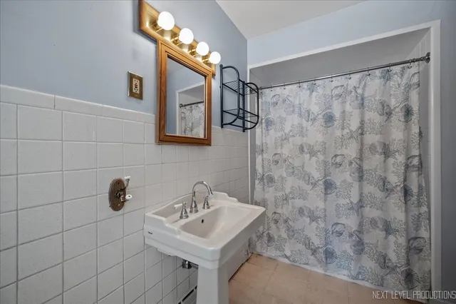 a bathroom with a sink a mirror and shower
