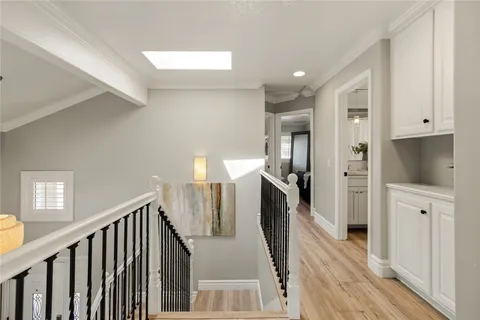 a view of entryway and hall with wooden floor