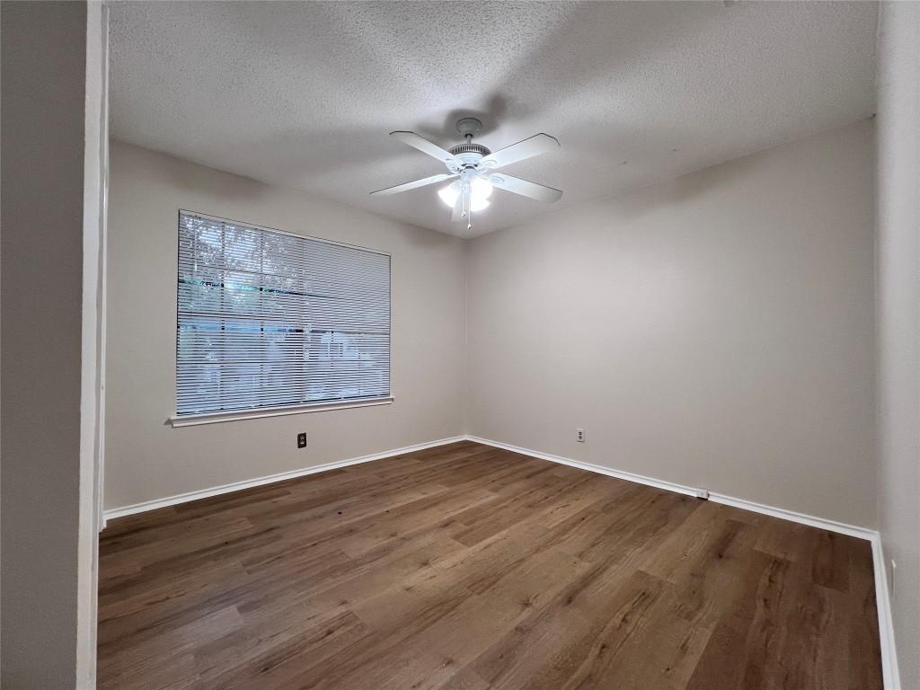 1518 White Oak Loop Round Rock, TX 78681 - Photo 14 of 17 wooden floor in an empty room with a window