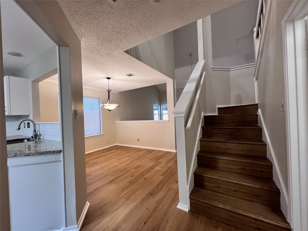 1518 White Oak Loop Round Rock, TX 78681 - Photo 2 of 17 a view of kitchen and hall with wooden floor