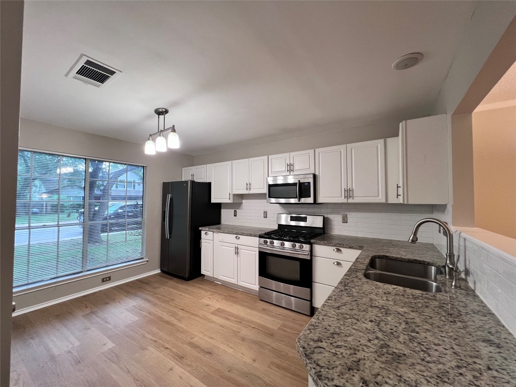 1518 White Oak Loop Round Rock, TX 78681 - Photo 4 of 17 a kitchen with stove a sink and refrigerator