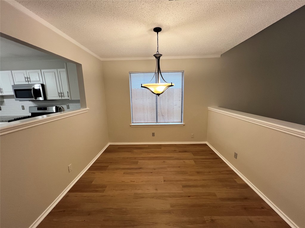 1518 White Oak Loop Round Rock, TX 78681 - Photo 5 of 17 a view of an empty room with window and wooden floor
