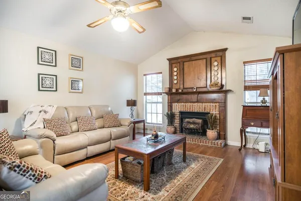 a living room with furniture and a fireplace