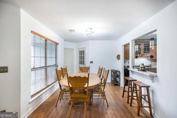 a view of a dining room with furniture window and wooden floor